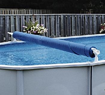 Pool cover reel on an above ground pool with fence